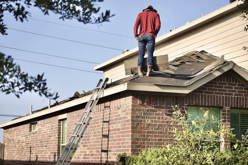 Professional roofer working on a residential roof in Jack Britt